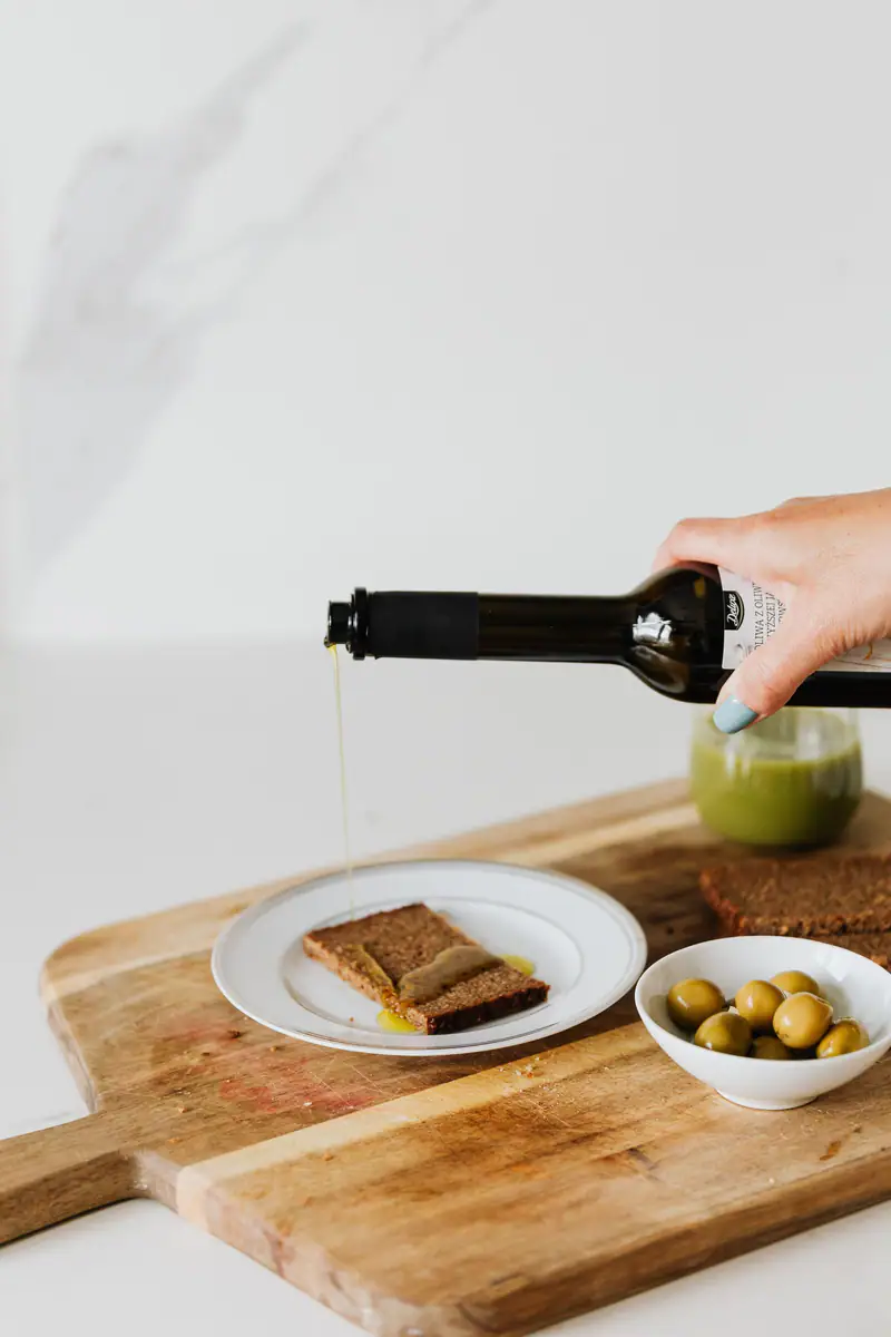 Olive oil poured over bread on a wooden board