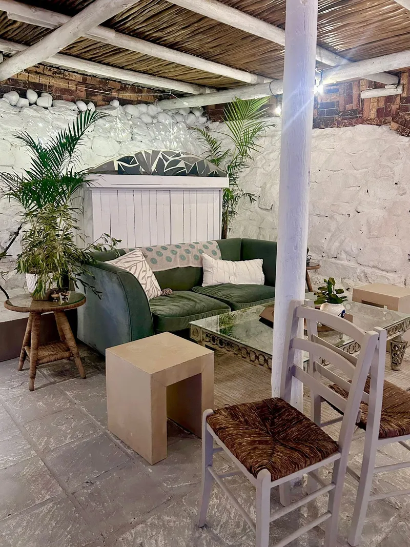 The courtyard lounge with a green sofa and palms