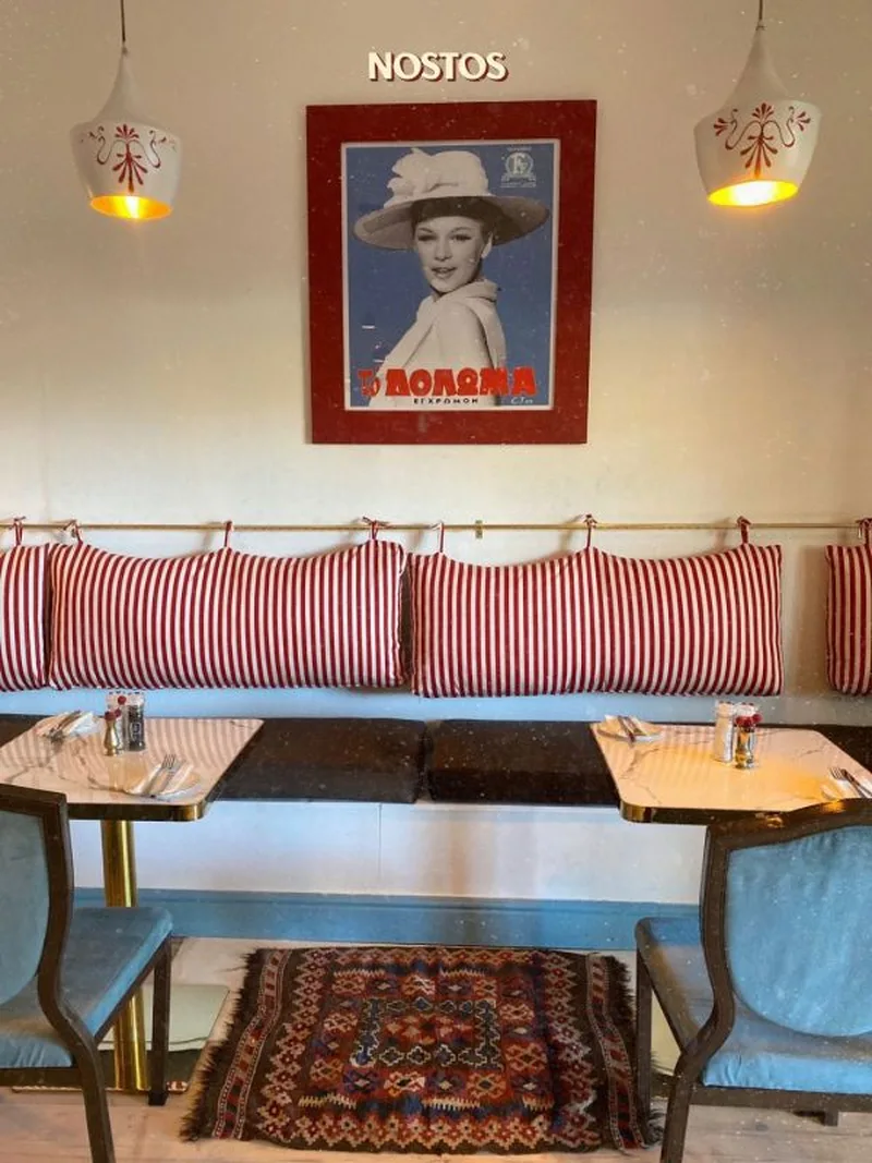 Red-and-white striped cushions under a vintage poster