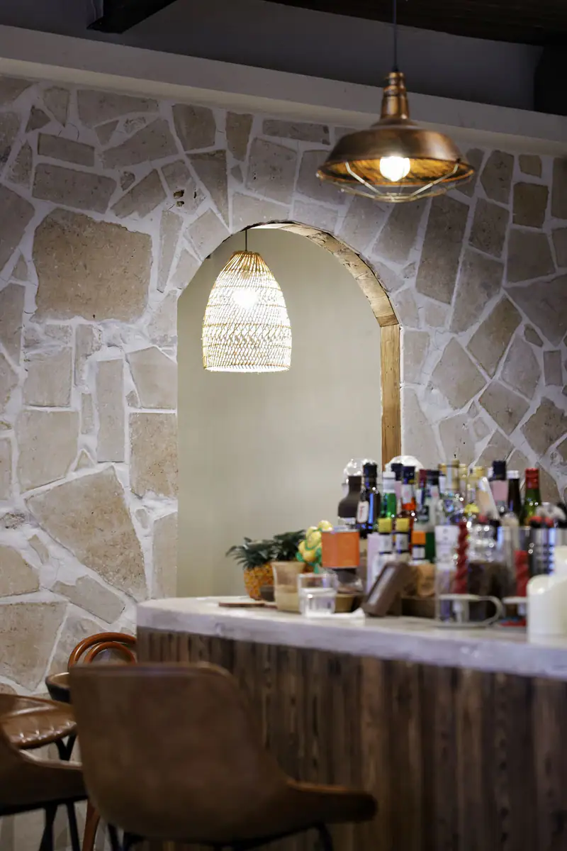 A whitewashed arched room with a laid table